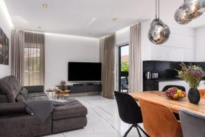 a living room with a table and a couch at Rusulica Trogir in Seget Vranjica