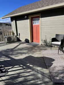 a house with a red door and a patio at The Cabin on Overland in Prescott