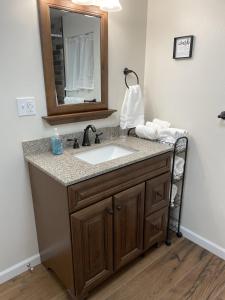 a bathroom with a sink and a mirror at The Cabin on Overland in Prescott +32 photos