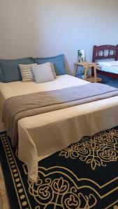 a large bed with blue pillows in a bedroom at Hostel do Cerrado in Cavalcante