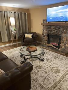 a living room with a couch and a fireplace at The Cabin on Overland in Prescott