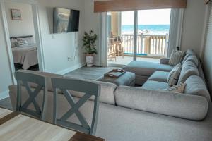 a living room with a couch and a view of the ocean at Perdido Key Beachfront 4BR Sleeps 12 Steps to the Beach Sweeping Gulf View in Pensacola