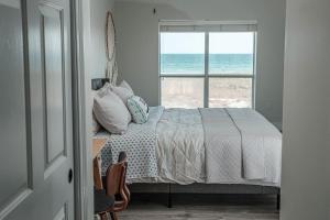 a bedroom with a bed with a view of the ocean at Perdido Key Beachfront 4BR Sleeps 12 Steps to the Beach Sweeping Gulf View in Pensacola