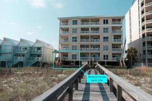 a sign on a boardwalk in front of a building at Perdido Key Beachfront 4BR Sleeps 12 Steps to the Beach Sweeping Gulf View in Pensacola +58 photos