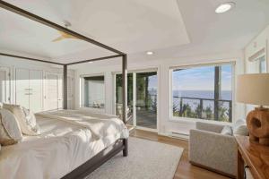 a bedroom with a bed and a view of the ocean at Boxer Bay in Tillamook