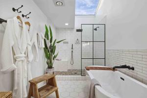 a white bathroom with a tub and a shower at Boxer Bay in Tillamook +41 photos