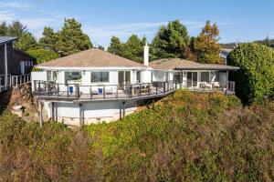 a large white house on a hill with trees at Boxer Bay in Tillamook
