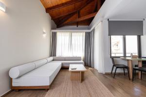 a living room with a couch and a table at Creta Elena in Chania +141 photos
