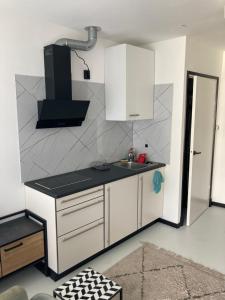 a kitchen with white cabinets and a sink at Sheepyhead in Dordrecht