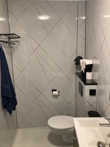 a white bathroom with a toilet and a sink at Sheepyhead in Dordrecht