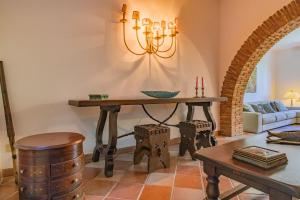 a living room with a table and a couch at Villa la Paolina in Marciana