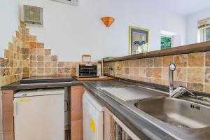 a kitchen with a sink and a counter top at Villa la Paolina in Marciana +79 photos