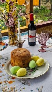 a table with a cake and a bottle of wine at Green Owl in Dedoplis Tskaro +41 photos