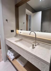 a bathroom with a sink and a mirror at Riviera Boutique Hotel by Pomo d'oro in Vlorë +22 photos