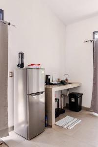 a kitchen with a stainless steel refrigerator and a counter at Casa Paula in Liberia +13 photos
