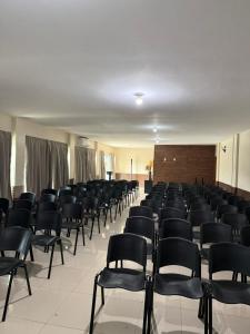 a room with rows of chairs in a building at Pousada de Itajuípe em Itajuípe in Itajuípe +56 photos