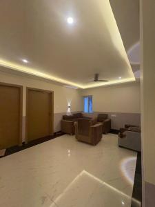 a large living room with couches and a ceiling at Lagoon Resort in Suitha