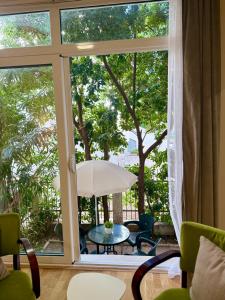 a patio with a table and chairs and an umbrella at Kanber Inn in Budva
