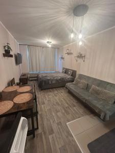 a living room with a couch and a table at Apartmán Míša in Harrachov