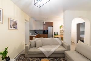 ein Wohnzimmer mit Sofa und eine Küche in der Unterkunft Kariatides in Sparta