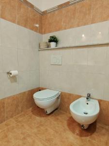 a bathroom with a toilet and a sink at M&C Home in Letojanni +22 photos
