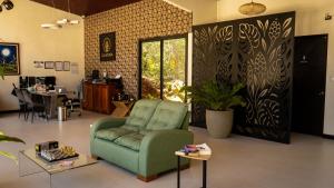 a living room with a green couch and a table at Calathea Hotel Monteverde in Monteverde Costa Rica