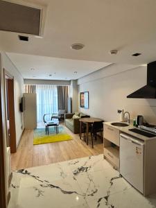 a kitchen and a living room with a table at Hay Rezidans in Istanbul