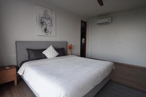 a bedroom with a large white bed in it at 030vollsamui in Ban Bang Po +8 photos