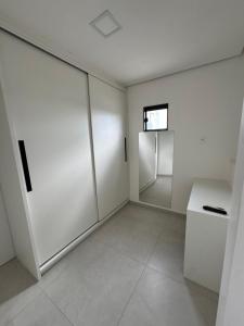 an empty room with white walls and a window at Flat Bugayalê Lounge in Garanhuns +5 photos