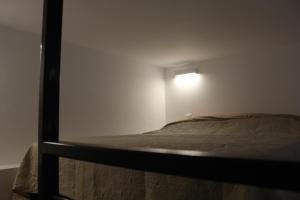 a bedroom with a bunk bed with a light on it at Kamara Studios in Alinda