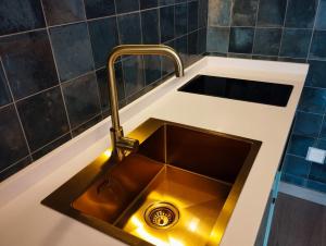 a kitchen sink with a faucet in a kitchen at Caldasia in Caldas de Reis +8 photos