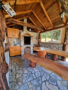a large room with a wooden bench in a cabin at Ethno Village Štitarica in Mojkovac
