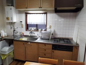 a small kitchen with a sink and a stove at Cozy Koharuka in Shima