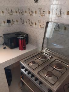 a kitchen with a stove top oven in a kitchen at Chez Mounas in Saint-Louis