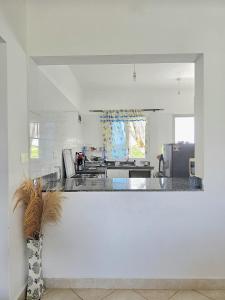 a white kitchen with a counter and a vase at Malindi Getaway, Near Beach in Malindi
