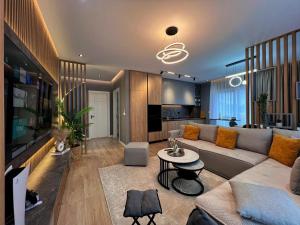 a living room with a couch and a table at Luxury Apartment in Shkodër