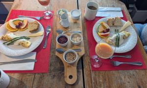 a wooden table with two plates of food on it at Auberge Les Blancs Moutons in Saint-Laurent-de-l'ile d'Orleans