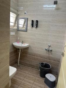 a bathroom with a sink and a toilet at Raaha Residency in Mysore +17 photos