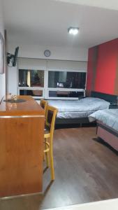 a bedroom with two beds and a desk and a desk at Apart Rilax in Buenos Aires +10 photos