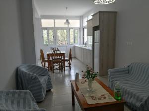 a living room with a couch and a table at Natalia's Serene Hub in Egina
