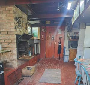 a room with a brick wall and a fireplace at 65 Rowweklip in Jongensfontein