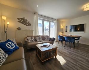 a living room with a couch and a table at FeWo "Seebär" Whg2 in Dahme