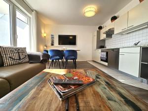 a living room with a couch and a table at FeWo "Seebär" Whg2 in Dahme