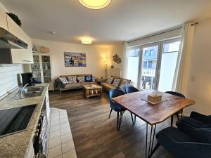 a living room with a table and a couch at FeWo "Seebär" Whg2 in Dahme