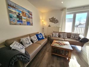 a living room with a couch and a coffee table at FeWo "Seebär" Whg2 in Dahme +14 photos