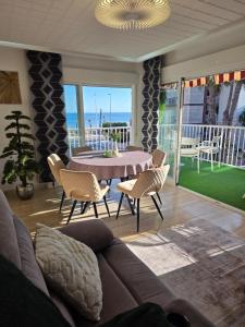 a living room with a couch and a table and chairs at Apartamento Mark in Santa Pola