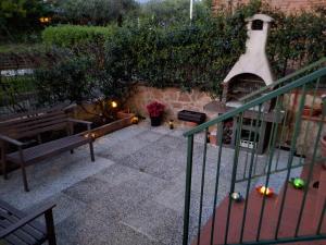 a outdoor patio with a fireplace and a bench at Imperiale in Sarzana