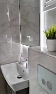 a white bathroom with a sink and a mirror at Dimis Home in Nea Plagia +12 photos