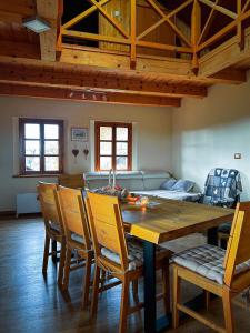 a dining room with a wooden table and chairs at Cozy Winehouse - Remote Vineyard Escape in Podčetrtek