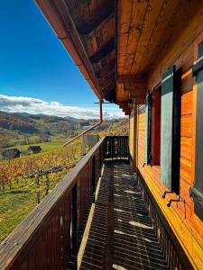a balcony of a house with a view of a vineyard at Cozy Winehouse - Remote Vineyard Escape in Podčetrtek